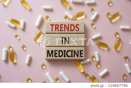 Medicine symbol. Concept words Trends in Medicine on wooden blocks. Beautiful pink background with pills. Medicine concept and Trends in Medicine. Copy space Medicine symbol. Concept words Trends in Medicine on wooden blocks. Beautiful pink background with pills. Medicine concept and Trends in Medicine. Copy space 124607790