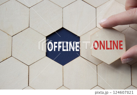 Offline or Online symbol. Concept word Offline or Online on wooden comb puzzle. Businessman hand. Beautiful deep blue background. Business and Offline or Online concept. Copy space 124607821