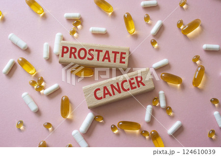 Prostate Cancer symbol. Concept word Prostate Cancer on wooden blocks. Beautiful pink background with pills. Medicine and Prostate Cancer concept. Copy space 124610039