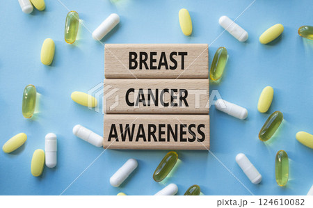 Breast Cancer Awareness symbol. Concept word Breast Cancer Awareness on wooden blocks. Beautiful blue background with pills. Medicine and Breast Cancer Awareness concept. Copy space Breast Cancer Awareness symbol. Concept word Breast Cancer Awareness on wooden blocks. Beautiful blue background with pills. Medicine and Breast Cancer Awareness concept. Copy space 124610082