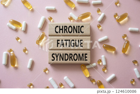Chronic Fatigue Syndrome symbol. Concept word Chronic Fatigue Syndrome on wooden blocks. Beautiful pink background with pills. Medicine and Chronic Fatigue Syndrome concept. Copy space Chronic Fatigue Syndrome symbol. Concept word Chronic Fatigue Syndrome on wooden blocks. Beautiful pink background with pills. Medicine and Chronic Fatigue Syndrome concept. Copy space 124610086