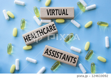 Medicine symbol. Concept words Virtual Healthcare Assistants on wooden blocks. Beautiful blue background with pills. Medicine concept and Virtual Healthcare Assistants. Copy space Medicine symbol. Concept words Virtual Healthcare Assistants on wooden blocks. Beautiful blue background with pills. Medicine concept and Virtual Healthcare Assistants. Copy space 124610092