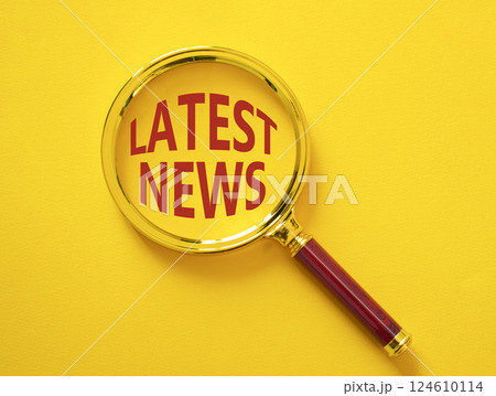 Latest News symbol. Concept word Latest News on magnifying glass. Beautiful yellow background. Business and Latest News concept. Copy space 124610114
