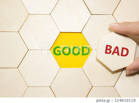 Good or Bad symbol. Concept word Good or Bad on wooden puzzle. Businessman hand. Beautiful yellow background. Business and Good or Bad concept. Copy space Good or Bad symbol. Concept word Good or Bad on wooden puzzle. Businessman hand. Beautiful yellow background. Business and Good or Bad concept. Copy space 124610119