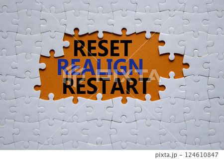 Reset Realign Restart symbol. Concept words Reset Realign Restart on white puzzle. Beautiful orange background. Business and Reset Realign Restart concept. Copy space. Reset Realign Restart symbol. Concept words Reset Realign Restart on white puzzle. Beautiful orange background. Business and Reset Realign Restart concept. Copy space. 124610847