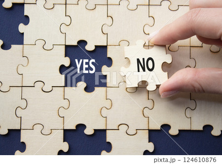 Yes or No symbol. Concept word Yes or No on wooden puzzle. Businessman hand. Beautiful deep blue background. Business and Yes or No concept. Copy space Yes or No symbol. Concept word Yes or No on wooden puzzle. Businessman hand. Beautiful deep blue background. Business and Yes or No concept. Copy space 124610876