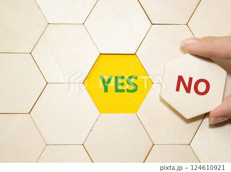 Yes or No symbol. Concept word Yes or No on wooden puzzle. Businessman hand. Beautiful yellow background. Business and Yes or No concept. Copy space 124610921