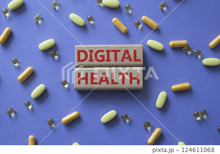 Digital Health symbol. Concept word Digital Health on wooden blocks. Beautiful purple background with pills. Medicine and Digital Health concept. Copy space 124611068