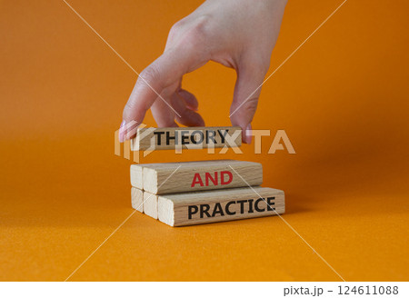 Theory and Practice symbol. Concept word Theory and Practice on wooden blocks. Businessman hand. Beautiful orange background. Business and Theory and Practice concept. Copy space 124611088