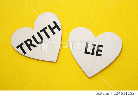 Truth or Lie symbol. Concept word Truth or Lie on wooden hearts. Beautiful yellow background. Business and Truth or Lie concept. Copy space Truth or Lie symbol. Concept word Truth or Lie on wooden hearts. Beautiful yellow background. Business and Truth or Lie concept. Copy space 124611152