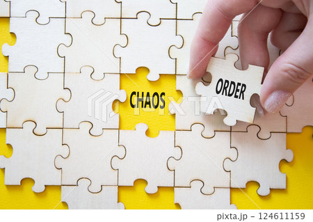 Chaos or Order symbol. Concept word Chaos or Order on wooden puzzle. Businessman hand. Beautiful white background. Business and Chaos or Order concept. Copy space Chaos or Order symbol. Concept word Chaos or Order on wooden puzzle. Businessman hand. Beautiful white background. Business and Chaos or Order concept. Copy space 124611159