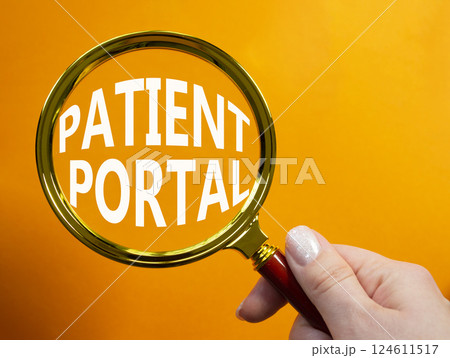 Patient Portal symbol. Magnifying glass with words Patient Portal. Businessman hand. Beautiful orange background. Medicine and Patient Portal concept. Copy space. 124611517