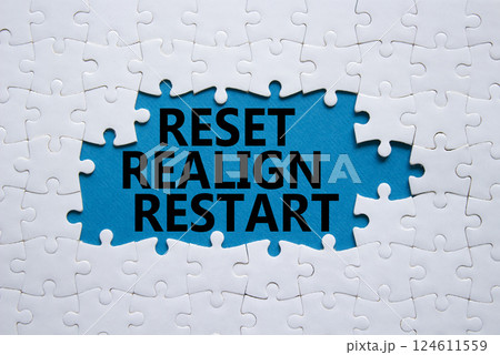 Reset Realign Restart symbol. Concept words Reset Realign Restart on white puzzle. Beautiful blue background. Business and Reset Realign Restart concept. Copy space. 124611559