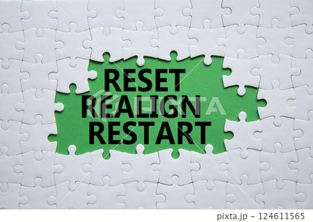 Reset Realign Restart symbol. Concept words Reset Realign Restart on white puzzle. Beautiful green background. Business and Reset Realign Restart concept. Copy space. 124611565