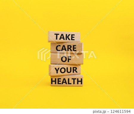 Health symbol. Wooden blocks with words Take Care of your Health. Beautiful yellow background. Health concept. Copy space. 124611594