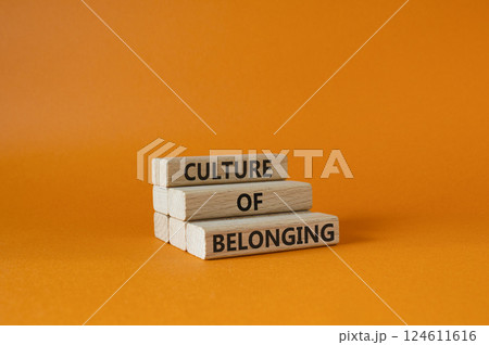 Culture of Belonging symbol. Wooden blocks with words Culture of Belonging. Beautiful orange background. Business and Culture of Belonging concept. Copy space. 124611616