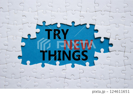 Try new Things symbol. Concept words Try new Things on white puzzle. Beautiful blue background. Business and Try new Things concept. Copy space. 124611651