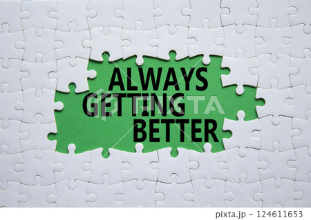 Always getting better symbol. White puzzle with words Always getting better. Beautiful green background. Business and Always getting better concept. Copy space. 124611653