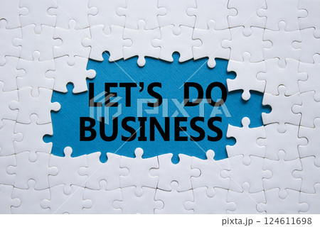 Lets do business symbol. Concept words Lets do business on white puzzle. Beautiful blue background. Business and Lets do business concept. Copy space. Lets do business symbol. Concept words Lets do business on white puzzle. Beautiful blue background. Business and Lets do business concept. Copy space. 124611698