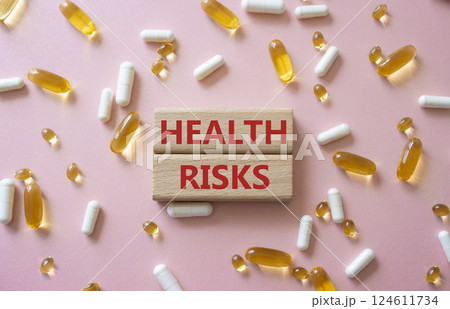 Health Risks symbol. Concept word Health Risks on wooden blocks. Beautiful pink background with pills. Medicine and Health Risks concept. Copy space Health Risks symbol. Concept word Health Risks on wooden blocks. Beautiful pink background with pills. Medicine and Health Risks concept. Copy space 124611734