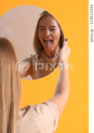 Woman Making a Playful Face in Mirror Woman Making a Playful Face in Mirror 124612044
