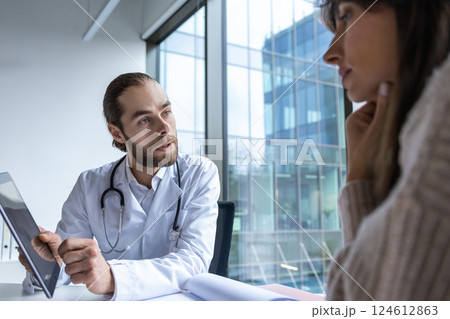 Male physician in lab using touchscreen tablet for medical consultation Male physician in lab using touchscreen tablet for medical consultation 124612863