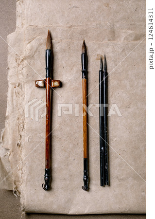 Traditional Chinese Calligraphy Brushes on Paper 124614311