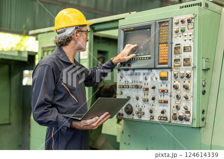 Senior Professional technician engineer male operate control heavy industry machine CNC in factory. Senior Professional technician engineer male operate control heavy industry machine CNC in factory. 124614339