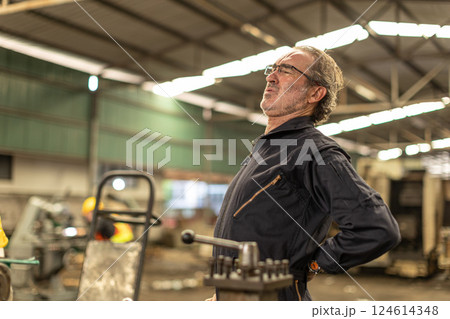 Senior worker tired exhausted muscle body pain suffer from hard work in heavy industry factory. Senior worker tired exhausted muscle body pain suffer from hard work in heavy industry factory. 124614348
