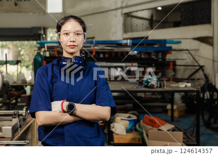 Portrait engineer women working in Lathe shop with metal machinery lathe milling machine, confident smart looking camera. Portrait engineer women working in Lathe shop with metal machinery lathe milling machine, confident smart looking camera. 124614357