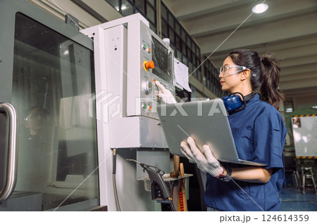 Engineer women working in Lathe shop with Digital CNC metal lathe milling machine, expert skillful industry worker female. Engineer women working in Lathe shop with Digital CNC metal lathe milling machine, expert skillful industry worker female. 124614359