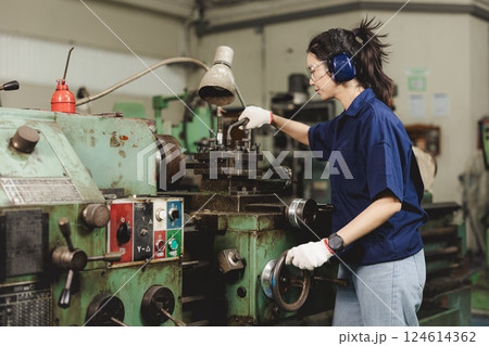 Engineer women working in Lathe shop with metal machinery lathe milling machine, expert skillful industry worker female. Engineer women working in Lathe shop with metal machinery lathe milling machine, expert skillful industry worker female. 124614362
