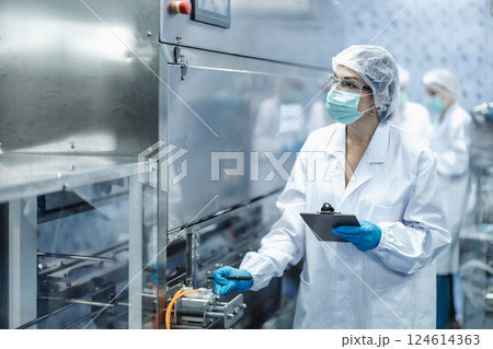 Industry inspector team working, QC staff work checking machine operation for safety and hygiene Industry inspector team working, QC staff work checking machine operation for safety and hygiene 124614363