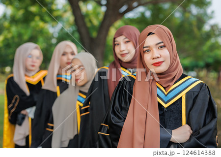 Group of Asian Muslim women Happy congratulation university outdoors. Arab hijab girls friend in bachelor college graduation school uniform. Group of Asian Muslim women Happy congratulation university outdoors. Arab hijab girls friend in bachelor college graduation school uniform. 124614388