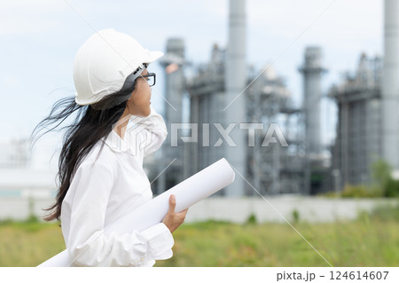 Professional smart vision young engineer women standing at refinery power plant building floor plan 124614607
