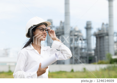 Professional smart vision young engineer women standing at refinery power plant building floor plan 124614609