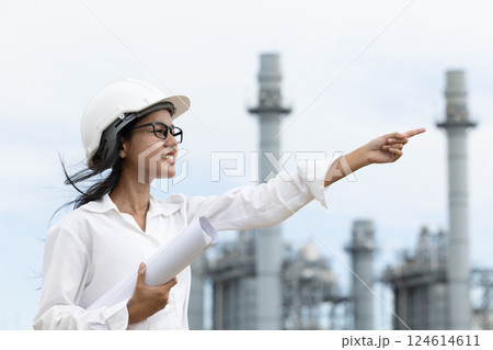 Professional smart vision young engineer women standing at refinery power plant building floor plan Professional smart vision young engineer women standing at refinery power plant building floor plan 124614611