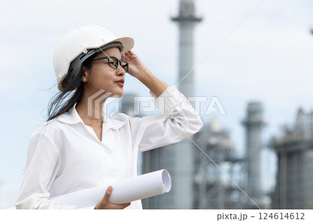 Professional smart vision young engineer women standing at refinery power plant building floor plan 124614612