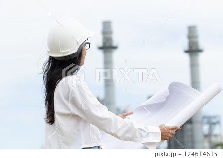 Professional smart vision young engineer women standing at refinery power plant building floor plan Professional smart vision young engineer women standing at refinery power plant building floor plan 124614615
