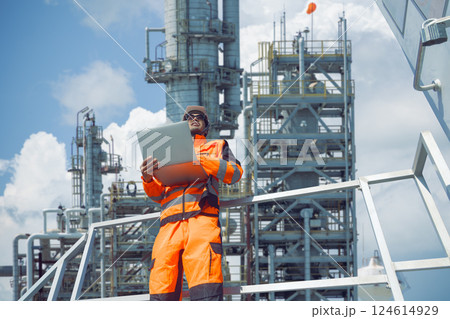 Professional Oil and Gas Petroleum Refinery worker on duty at crude oil distillation tower Asian man Professional Oil and Gas Petroleum Refinery worker on duty at crude oil distillation tower Asian man 124614929