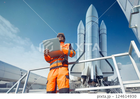 Professional engineer working in rocket lunch pad with laptop for control operate spaceship liftoff 124614930