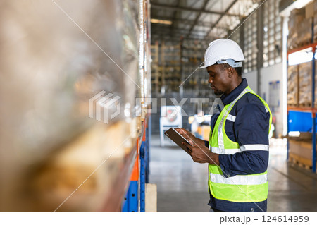 african black professional warehouse worker. stock inventory staff employee working in cargo storage 124614959