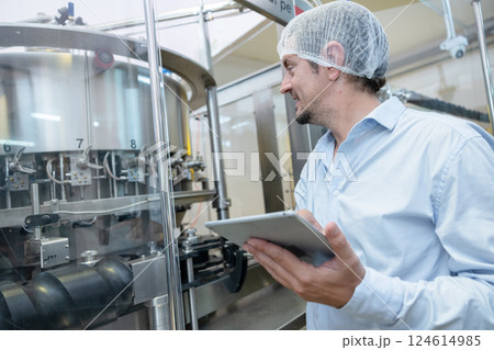 professional engineer technician man service check machine in drink factory for quality standard 124614985