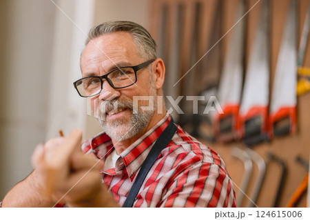 Professional carpenter man working with wood piece design furniture in workshop in wood factory Professional carpenter man working with wood piece design furniture in workshop in wood factory 124615006
