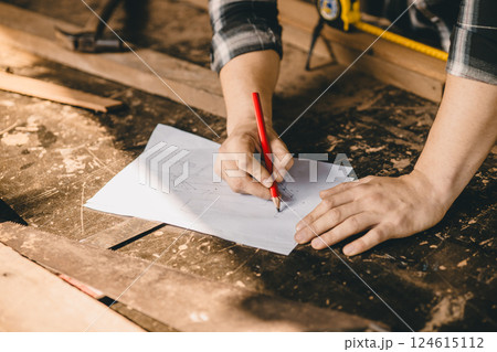 Carpenter man hand craft sketch drawing design wood furniture in wood workshop making wood project. Carpenter man hand craft sketch drawing design wood furniture in wood workshop making wood project. 124615112