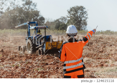 Builder worker work in construction site wearing safety suit control operate land leveling process 124615118