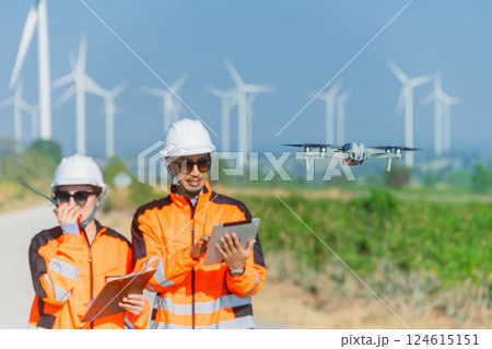Engineer team using drone technology device to survey service maintenance wind turbine power station 124615151