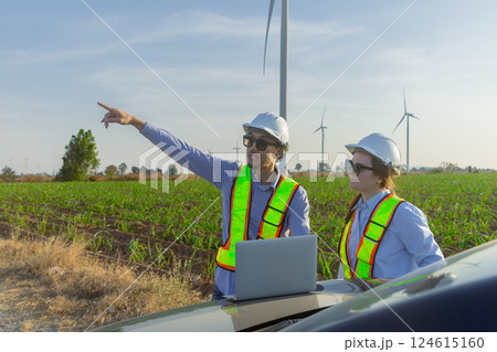 Engineer architect field work outdoor together survey construction wind turbine at agriculture field Engineer architect field work outdoor together survey construction wind turbine at agriculture field 124615160