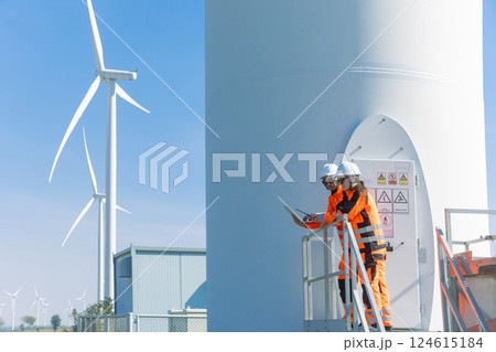 Engineer workers teamwork working together service maintenance wind turbine clean power green energy 124615184
