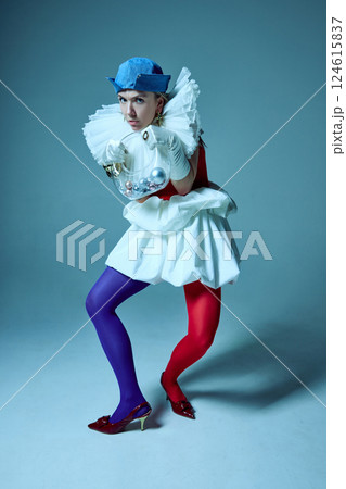 Fashion-forward woman pressing hands against corset, playing with form and silhouette in artistic styling. Fashion-forward woman pressing hands against corset, playing with form and silhouette in artistic styling. 124615837